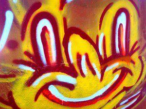 A cheery graffiti face on a bridge pillar seen on a run in Oakland.