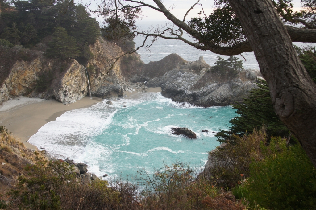 Nice blue bay in Julia Pffeifer Burns State Park, with McWay Falls pouring out of the cliff.