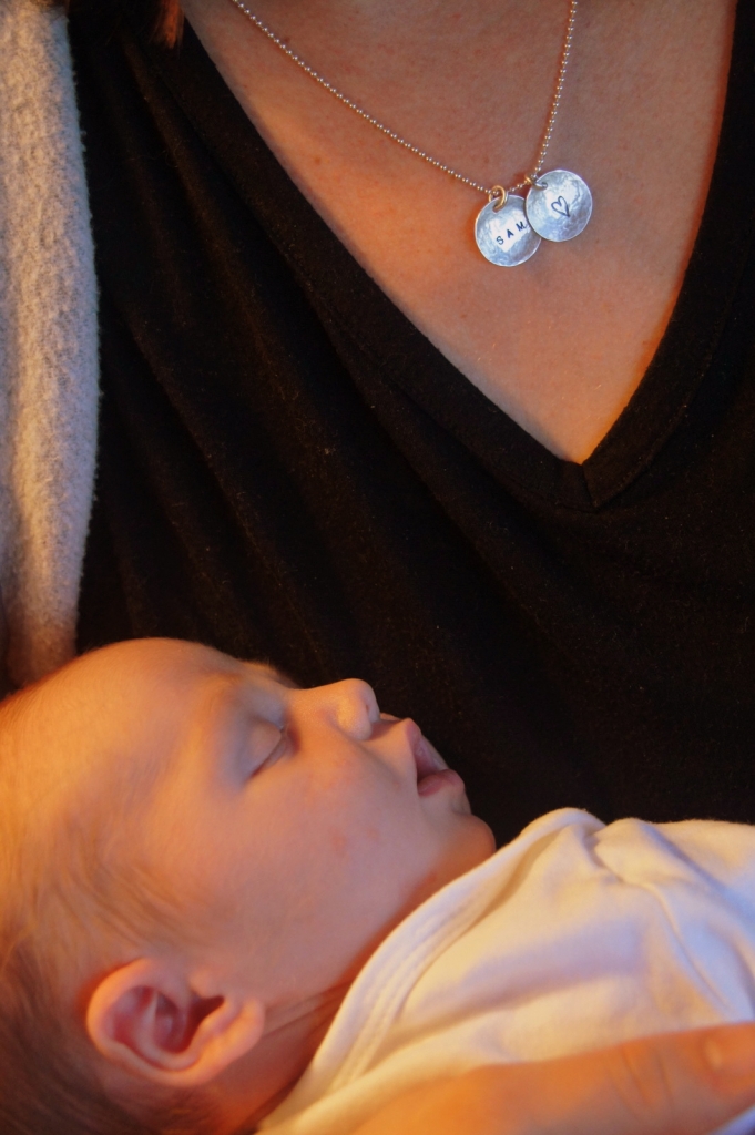 Daya's necklace engraved with her baby's name and the slumbering champ himself.