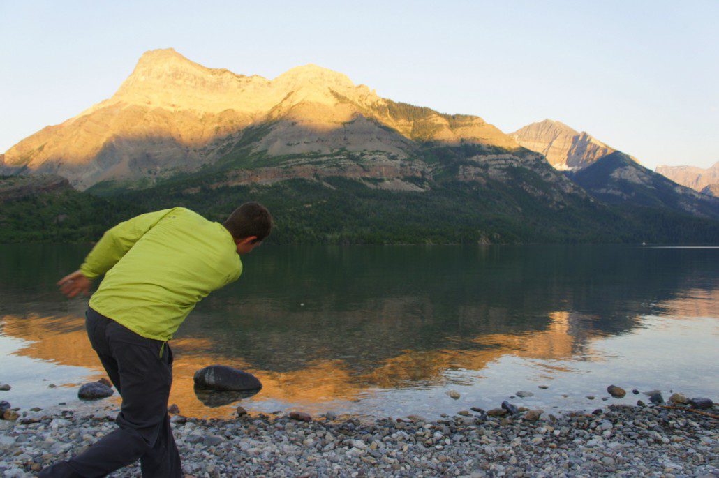 Skipping rocks in Waterton, Alberta at sunset.