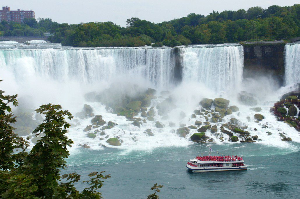 A tour boat cruises below American Falls, which carries about 1/10 the water of Horseshoe Falls.