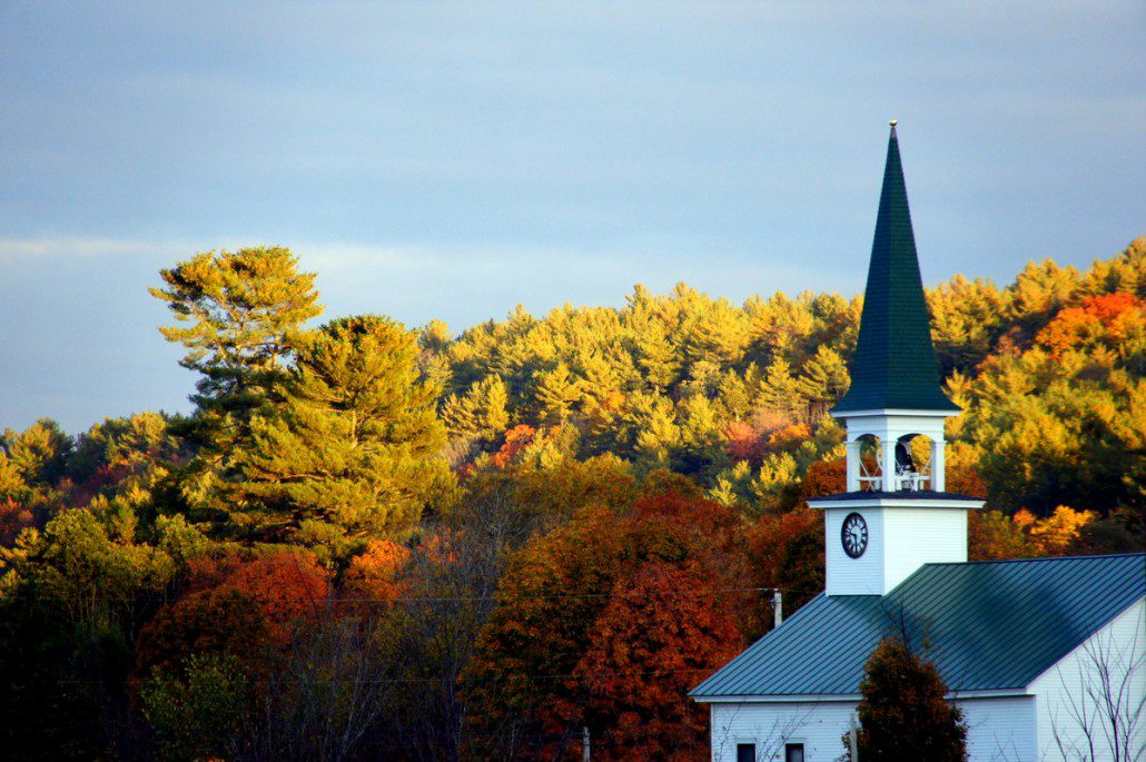 New Hampshire! Sunset on the foliage and a church.