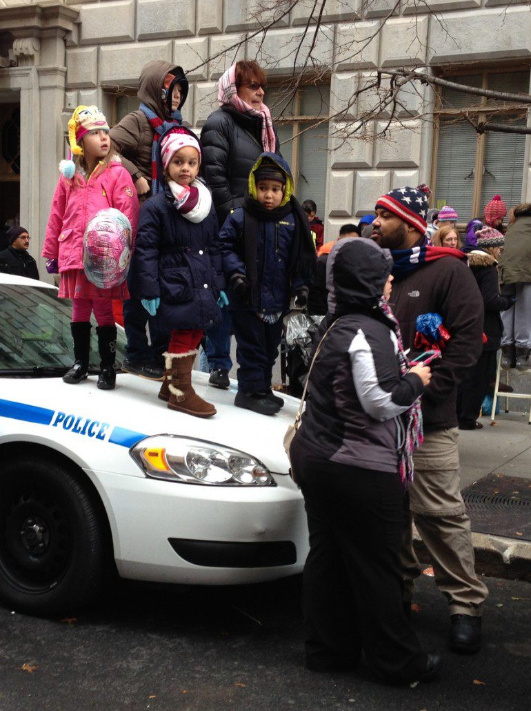 Kids snag a better view of the parade. (C photo credit)