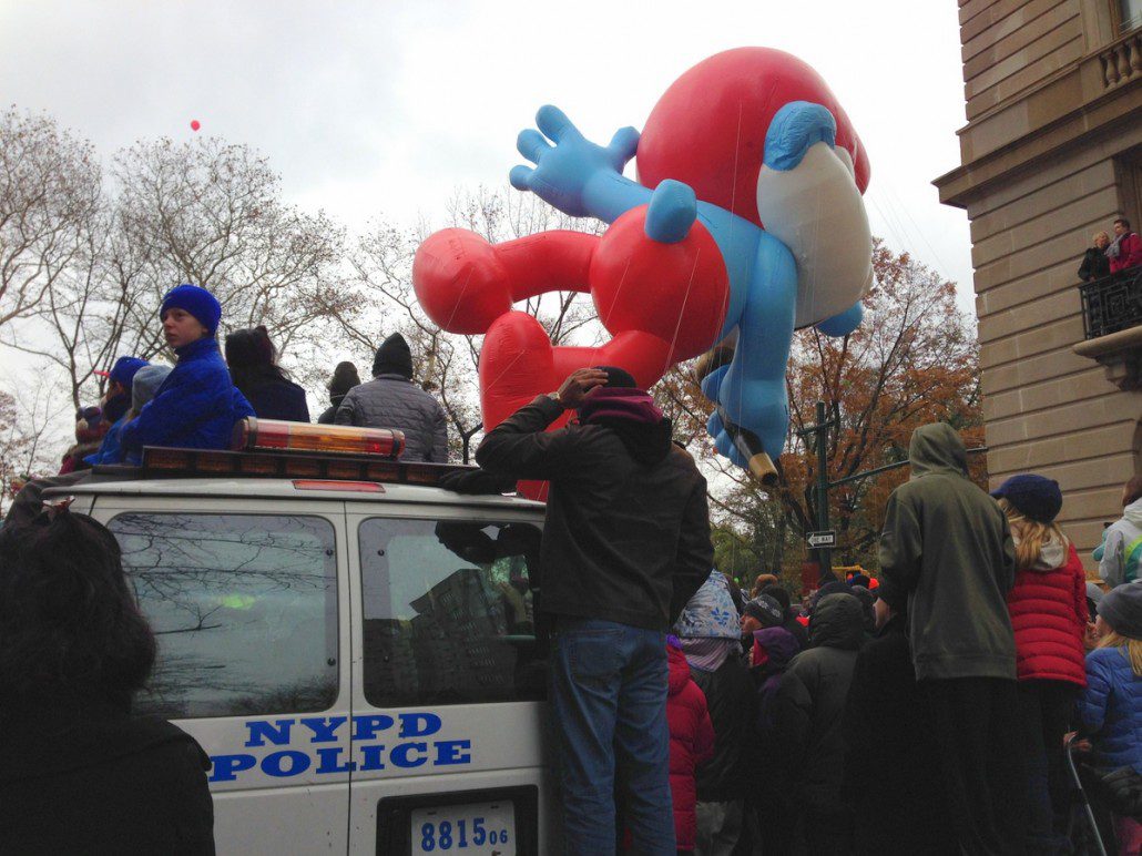 Papa Smurf rolls on by as kids watch from the top of a police van (C photo credit)