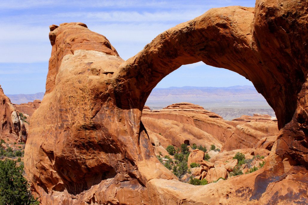 A view of the desert through an arch.