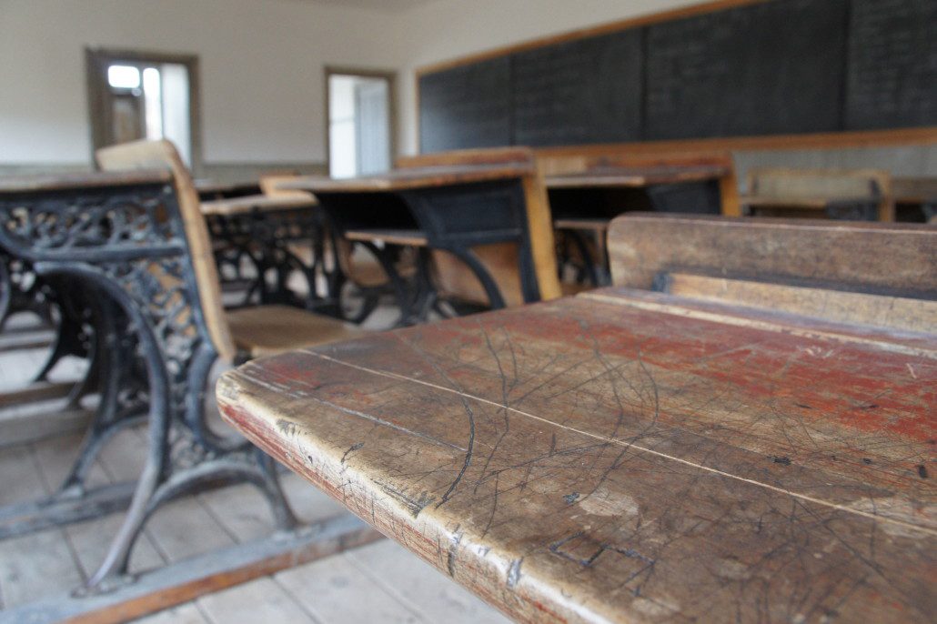 Years of lessons are carved into a desk in the one-room school house.