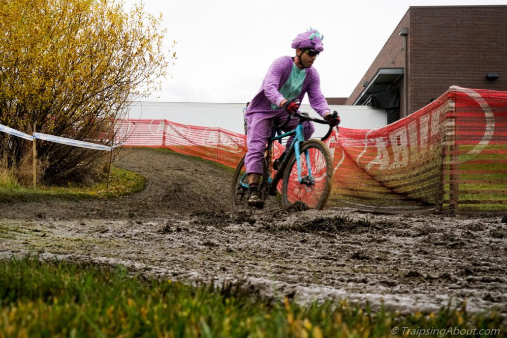 I'm not sure what's tougher, riding in deep mud or a purple dinosaur costume...