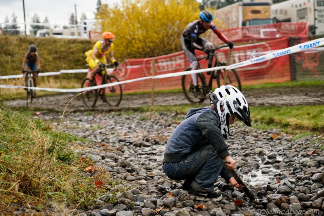 A future shredder playing in the mud while his dad races.